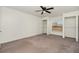 Bedroom featuring a closet and window, with neutral colored walls and carpet at 6087 Sunset Vista Dr, Lakeland, FL 33812