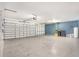 Spacious two car garage with gray concrete flooring and room for storage and tool organization at 6087 Sunset Vista Dr, Lakeland, FL 33812