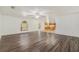 Bright living room with hardwood floors, large windows, and an open layout with kitchen at 6087 Sunset Vista Dr, Lakeland, FL 33812