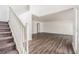 Open-concept living area with wood laminate flooring, a staircase, and plenty of natural light at 6087 Sunset Vista Dr, Lakeland, FL 33812