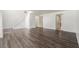 Spacious living room with wood laminate floors, stairway access and a neutral color palette at 6087 Sunset Vista Dr, Lakeland, FL 33812