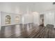 Bright and airy living room with wood laminate flooring and a staircase that adds architectural interest at 6087 Sunset Vista Dr, Lakeland, FL 33812