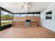 Outdoor kitchen includes an oven, tiled backsplash and plenty of counter space for meal preparation at 6087 Sunset Vista Dr, Lakeland, FL 33812