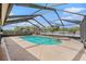 A private pool is surrounded by a screened enclosure and includes a built in hot tub for relaxation at 6087 Sunset Vista Dr, Lakeland, FL 33812