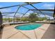 A private pool is surrounded by a screened enclosure and includes a built in hot tub for relaxation at 6087 Sunset Vista Dr, Lakeland, FL 33812