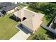 Aerial view of a home with a neutral shingle roof, long driveway, and manicured lawn at 703 New York Ave, South Daytona, FL 32119