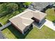An aerial view of a home reveals a neutral shingle roof, a long driveway, and a well-kept lawn at 703 New York Ave, South Daytona, FL 32119