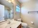 Bathroom features a vanity sink, mirror and walk-in shower at 703 New York Ave, South Daytona, FL 32119