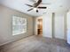 Bedroom featuring carpet floors, a ceiling fan, and an ensuite bathroom at 703 New York Ave, South Daytona, FL 32119