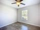This bedroom has wood-look floors and a window with blinds at 703 New York Ave, South Daytona, FL 32119