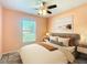 This bedroom boasts cozy decor and large window at 703 New York Ave, South Daytona, FL 32119