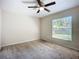 Large bedroom with neutral walls, carpet floors, and a bright window at 703 New York Ave, South Daytona, FL 32119
