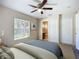 Cozy bedroom with a ceiling fan, carpet floors, and a window overlooking the backyard at 703 New York Ave, South Daytona, FL 32119