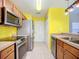 Bright eat-in kitchen features stainless steel appliances and tile flooring at 703 New York Ave, South Daytona, FL 32119