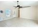 Bright, neutral-colored living room with tile floors and a large window bringing in natural light at 703 New York Ave, South Daytona, FL 32119