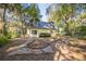 Exterior of the two-story home with a deck, showcasing the lush greenery and spacious backyard at 9401 Cat Track Trl, Lake Wales, FL 33898