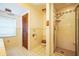 Bathroom with a shower and separate toilet with tile flooring and neutral colored wall tiles at 9401 Cat Track Trl, Lake Wales, FL 33898