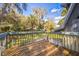 Exterior view of deck area with wooden railings, offering scenic views of lush greenery at 9401 Cat Track Trl, Lake Wales, FL 33898
