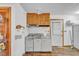 View of a kitchen area featuring wood cabinets, white appliances, and tile backsplash at 9401 Cat Track Trl, Lake Wales, FL 33898