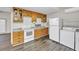 An efficient kitchen with wood cabinets, and a white refrigerator and stove at 9401 Cat Track Trl, Lake Wales, FL 33898