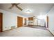 Spacious living area with carpet and hardwood floors, leading to a functional kitchen space at 9401 Cat Track Trl, Lake Wales, FL 33898