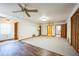 Expansive living area featuring carpet, hardwood floors, doors, and ceiling fans at 9401 Cat Track Trl, Lake Wales, FL 33898