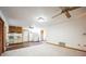 Open living area with carpet and hardwood, seamlessly connecting to the kitchen with ceiling fans at 9401 Cat Track Trl, Lake Wales, FL 33898