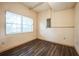 Cozy room featuring hardwood flooring, natural light from a window, and neutral walls at 9401 Cat Track Trl, Lake Wales, FL 33898