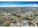 Beautiful neighborhood aerial view with a water feature; one-story home with blue siding at 3322 Heather Glynn Dr, Mulberry, FL 33860