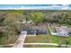 Aerial view of single story home with well maintained lawn and driveway and lake in neighborhood at 3322 Heather Glynn Dr, Mulberry, FL 33860