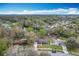 Beautiful neighborhood aerial view with a water feature; one-story home with blue siding at 3322 Heather Glynn Dr, Mulberry, FL 33860