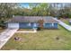 Aerial view of a blue single story home with an attached garage and large front lawn at 3322 Heather Glynn Dr, Mulberry, FL 33860