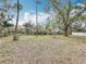 Large backyard with lush trees and a view of the neighborhood lake at 3322 Heather Glynn Dr, Mulberry, FL 33860