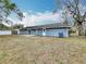 Backyard view of the home, with a well maintained lawn and ample space at 3322 Heather Glynn Dr, Mulberry, FL 33860