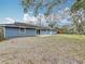 Backyard view of the home, with a well maintained lawn and ample space at 3322 Heather Glynn Dr, Mulberry, FL 33860