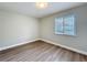 Bedroom features wood-look floors, neutral walls, and a window for natural light at 3322 Heather Glynn Dr, Mulberry, FL 33860