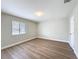 Spacious bedroom with new floors, a window with blinds, and fresh neutral paint at 3322 Heather Glynn Dr, Mulberry, FL 33860