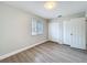 Cozy bedroom with wood-look flooring, closet, and a window for natural light at 3322 Heather Glynn Dr, Mulberry, FL 33860