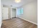 Empty bedroom featuring wood-look floors, neutral walls, a window, and a closet at 3322 Heather Glynn Dr, Mulberry, FL 33860