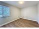 Empty bedroom showcasing hardwood-style floors and ample natural light from the window at 3322 Heather Glynn Dr, Mulberry, FL 33860