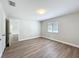 Bright bedroom featuring wood-look floors, neutral walls, and a window for natural light at 3322 Heather Glynn Dr, Mulberry, FL 33860