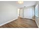This bedroom features wood floors, a window with blinds, and a double door closet at 3322 Heather Glynn Dr, Mulberry, FL 33860