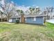 Charming single-story home with blue siding, brick chimney, and well-maintained front lawn at 3322 Heather Glynn Dr, Mulberry, FL 33860