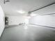 Spacious garage with a hot water heater and access to an attic storage space at 3322 Heather Glynn Dr, Mulberry, FL 33860