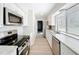 Modern kitchen with stainless steel appliances, white cabinets, and marble countertops at 3322 Heather Glynn Dr, Mulberry, FL 33860