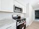 Modern kitchen featuring stainless steel appliances and sleek, white marble countertops at 3322 Heather Glynn Dr, Mulberry, FL 33860