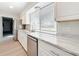 Bright kitchen with stainless appliances, sleek marble countertops, and white cabinetry at 3322 Heather Glynn Dr, Mulberry, FL 33860