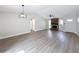 Bright living space features a brick fireplace, modern lighting, and wood-look flooring at 3322 Heather Glynn Dr, Mulberry, FL 33860