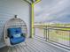 Comfortable balcony seating with blue cushion and a decorative pillow offers views of the building at 7517 Laureate Blvd # 4303, Orlando, FL 32827