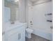 Bright bathroom with a modern vanity, white tiled shower and neutral walls creates a relaxing atmosphere at 7517 Laureate Blvd # 4303, Orlando, FL 32827